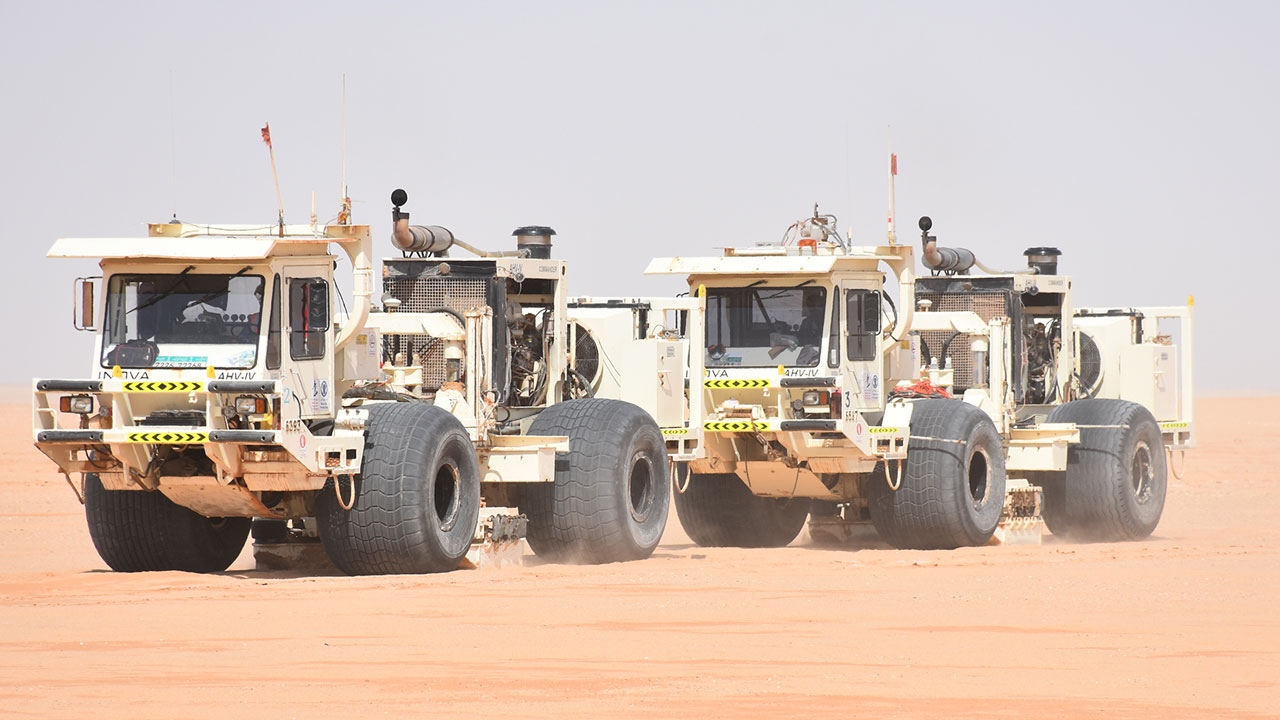 Close up of seismic vibrator trucks in the desert