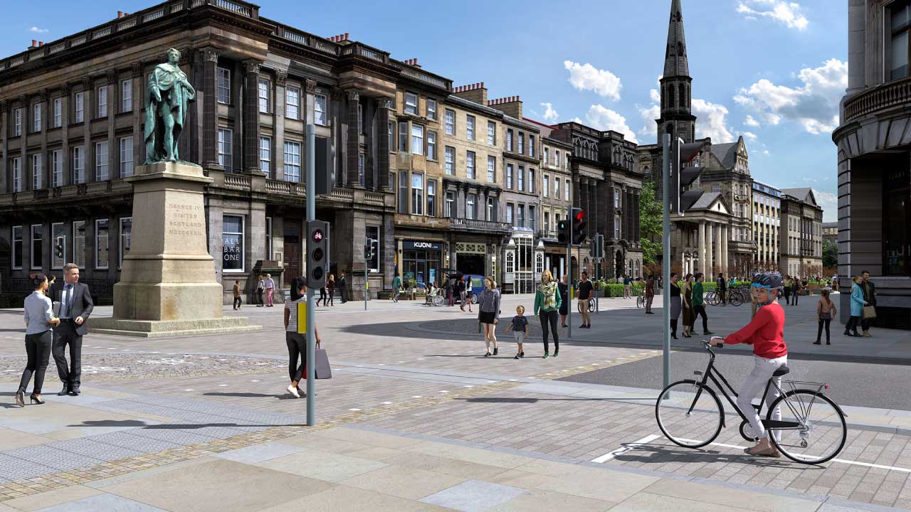 A busy urban square featuring a statue, pedestrians, and a cyclist waiting at a traffic light
