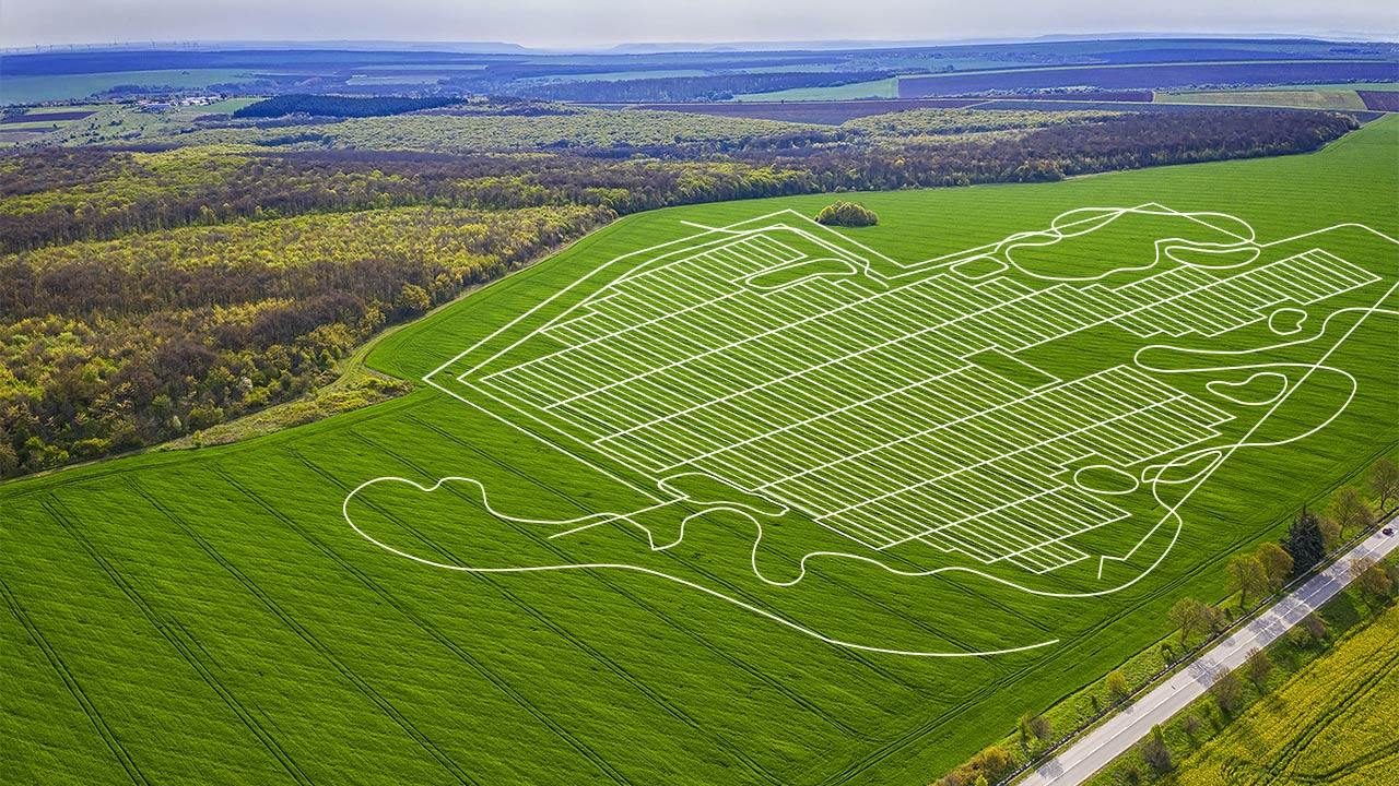 Line drawing of a solar site layout over a green field