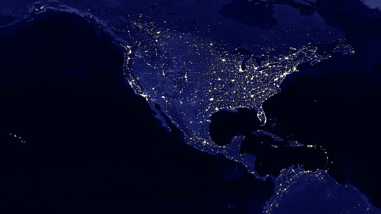Grid reliability represented by blue image taken from space of North America at night with lights crisscrossing the land