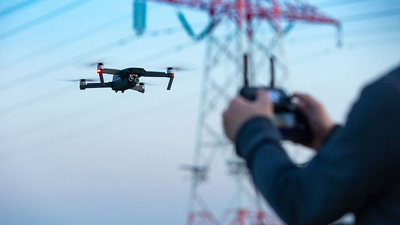 A drone remotely collects utility tower data