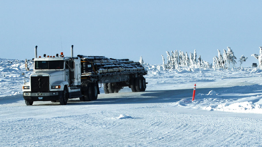 Truck driving off a portage onto a lake