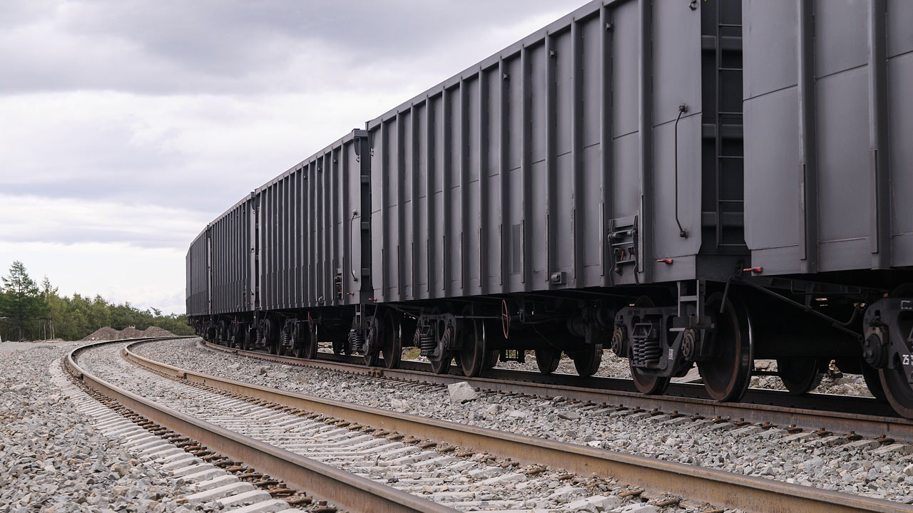 Train cars and tracks stretching to the horizon