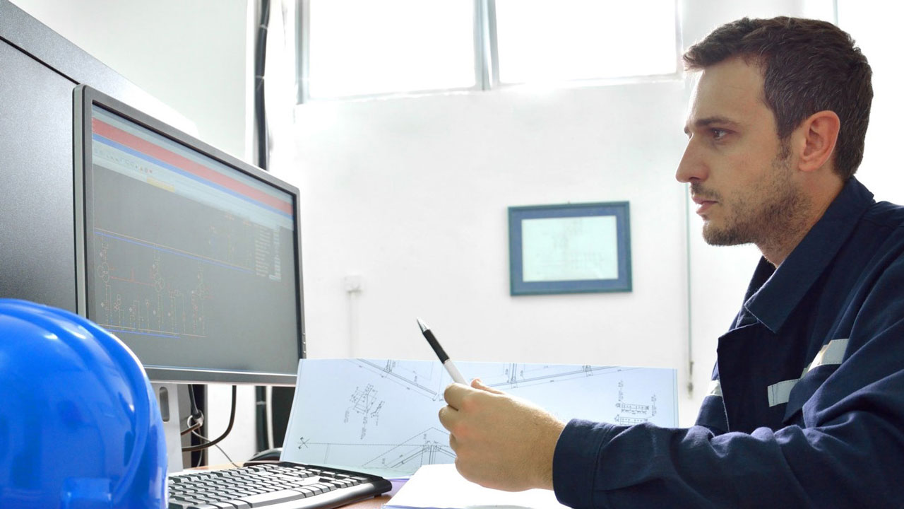 Compliance specialist reviewing landfill air permitting data on a computer screen