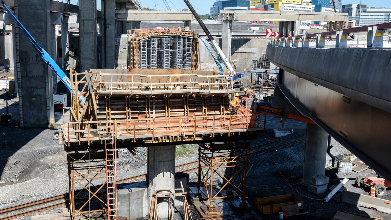 Construction site of a tunnel and bridges, near old structures in demolition process