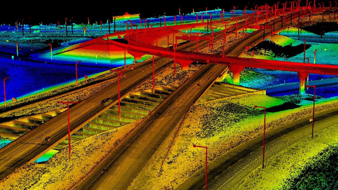 Rainbow-hued LiDAR point cloud image of streets and bridges