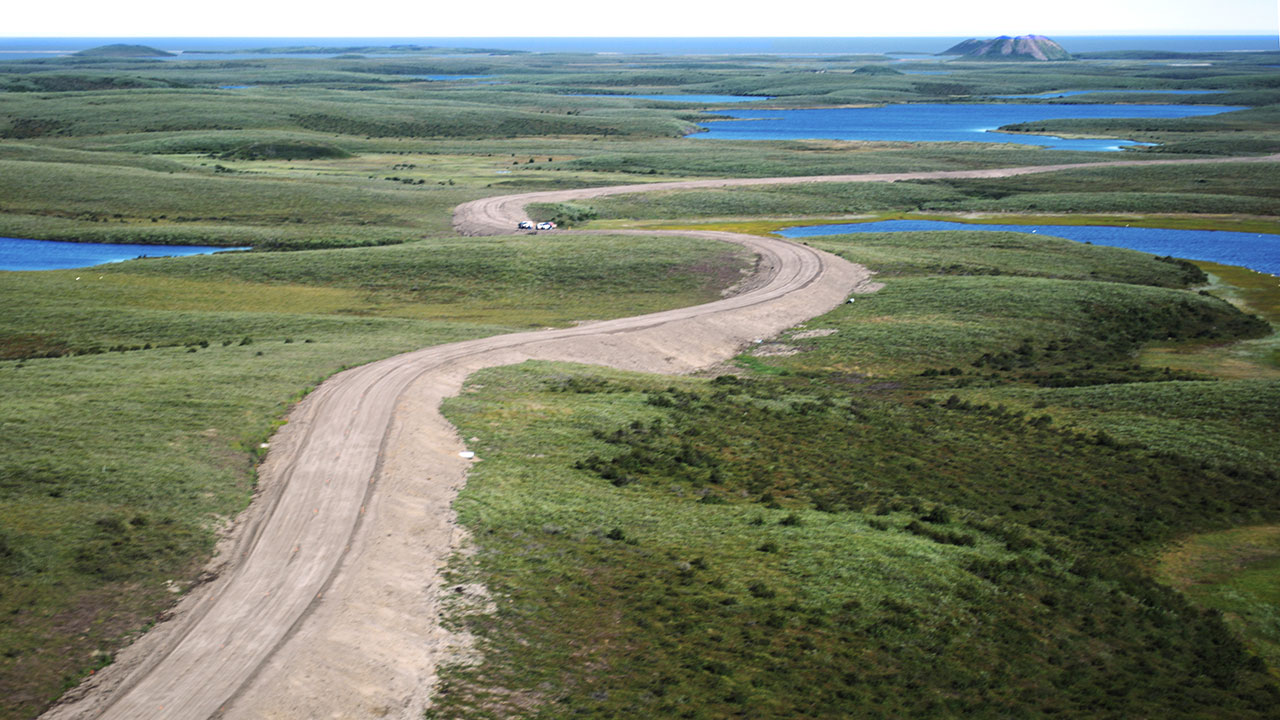 Inuvik Tuktoyaktuk Highway - Alignment approaching Tuktoyaktuk and looking northeast towards Ibyuk Pingo, part of the Pingo Canadian Landmark