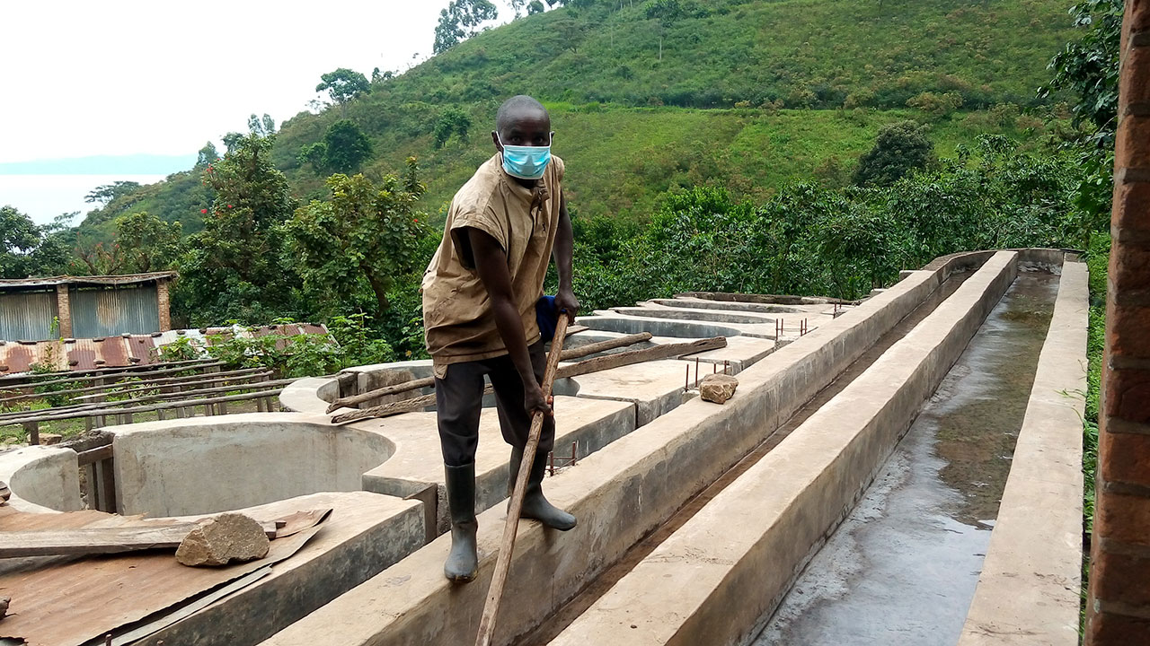 Cleaning the grading channel at the Kazo washing station in Kalehe