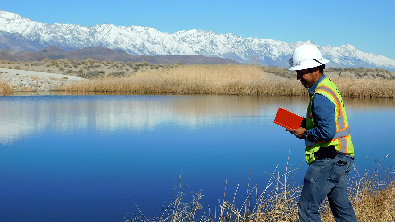 Tetra Tech employee standing in front of body of water in Owens Lake, California