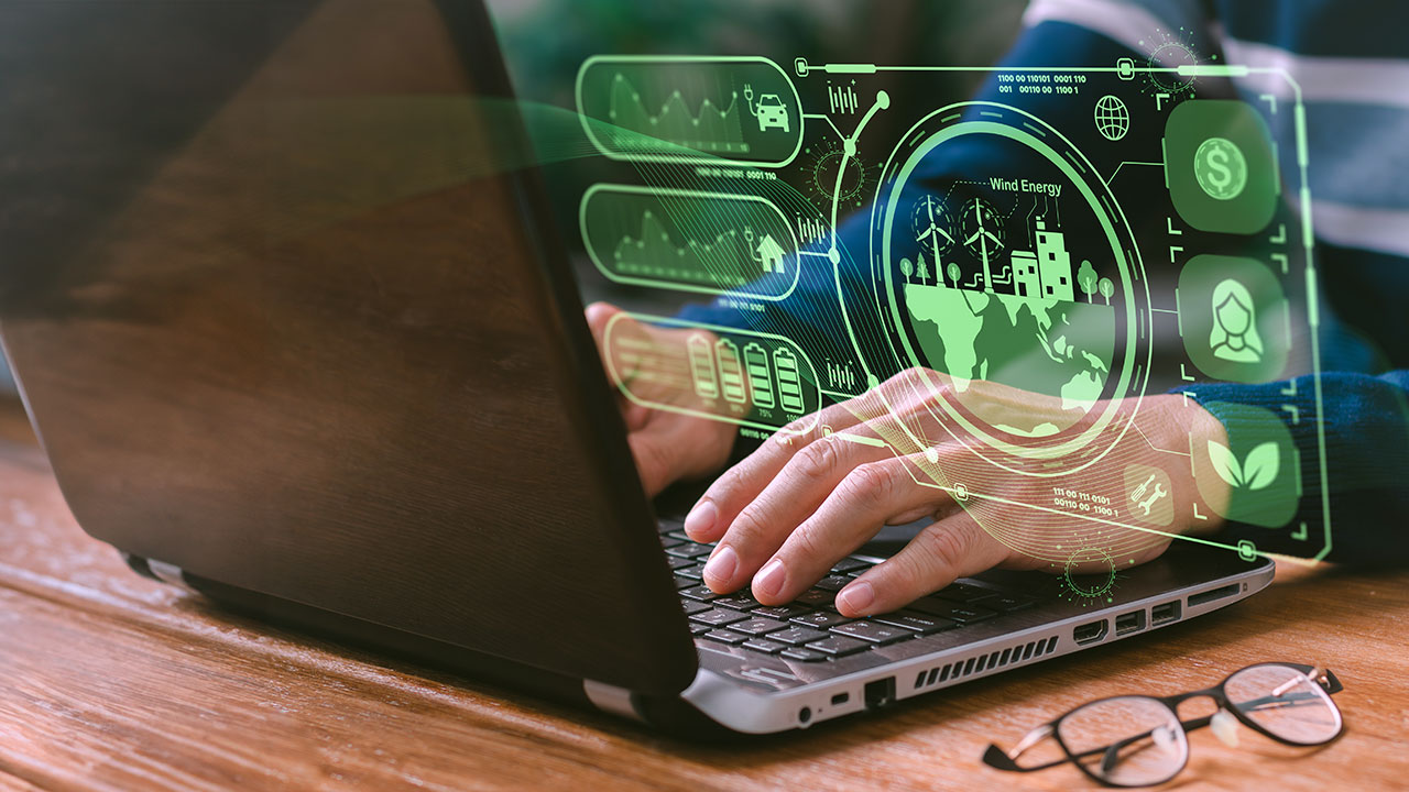 A close up of a person typing on a laptop with a floating digital interface depicting digital EHS