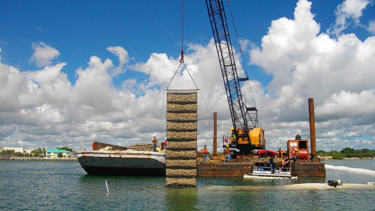 Sand-filled geotextile tubes and marine mattresses form the foundation for the large breakwater island at Fort Pierce