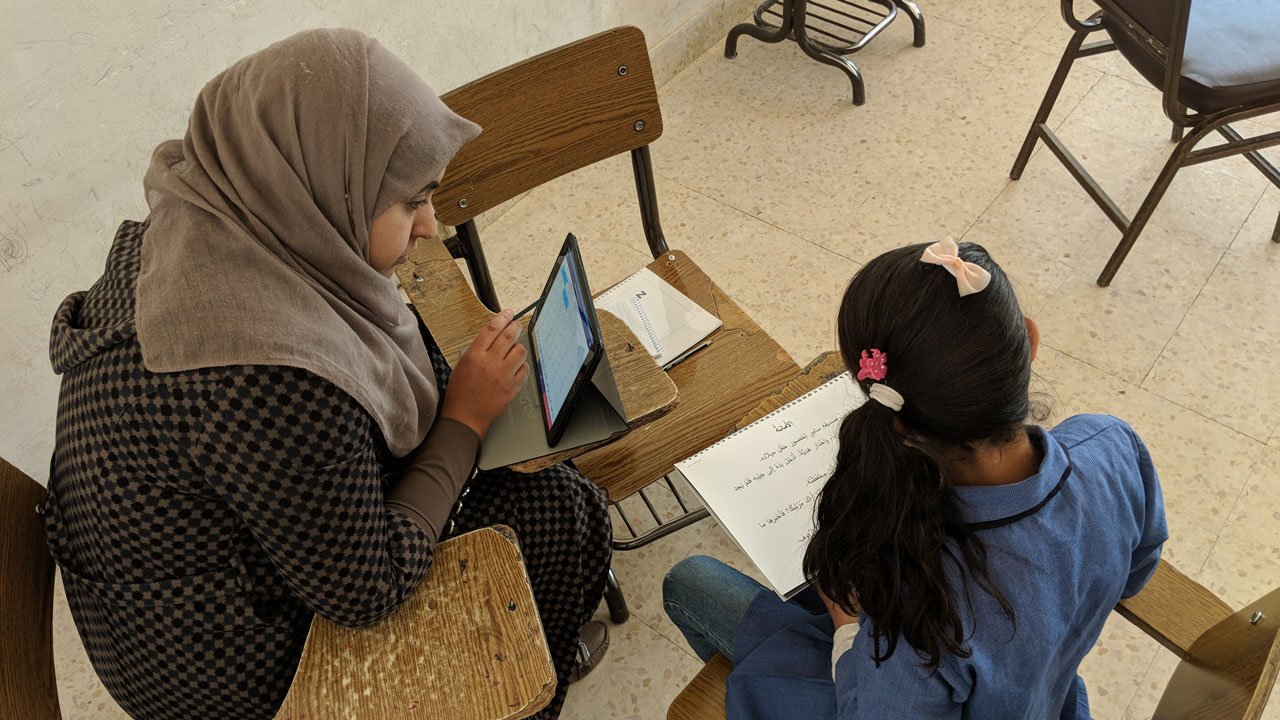 Enumerator evaluates child education using a tablet in Jordan