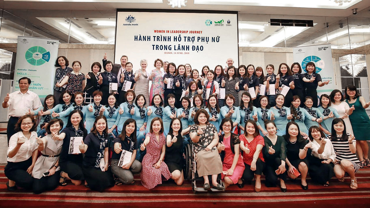 Group photo of women on stage in Vietnam