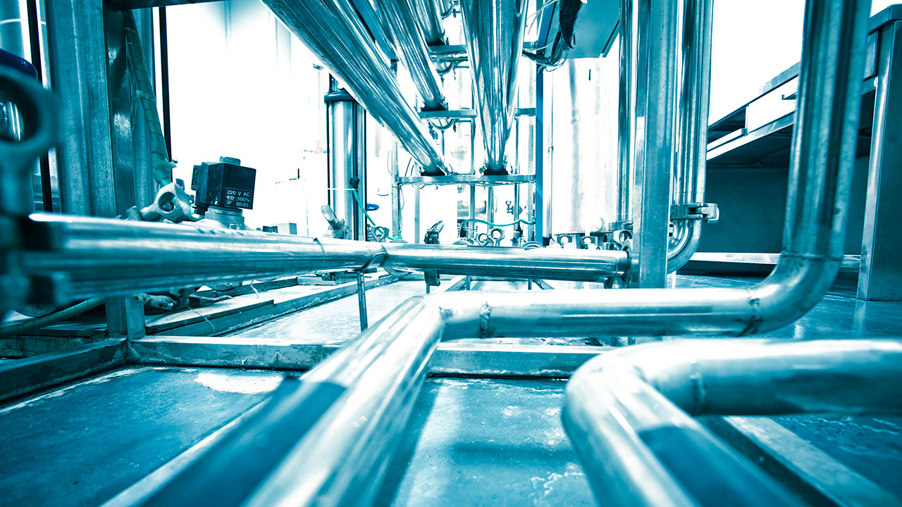 Image with a blue tint depicting steel pipes