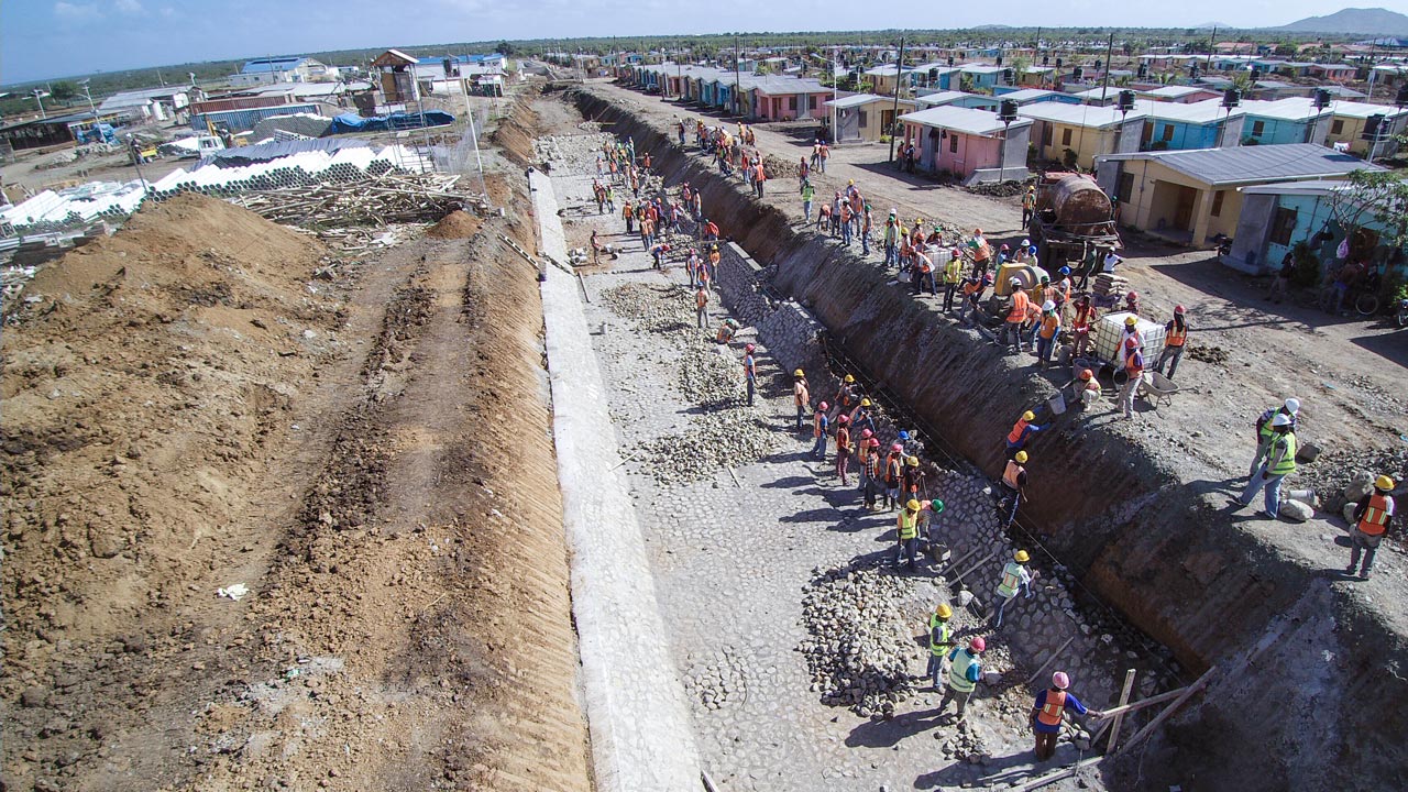 Group of engineers assess a drainage canal design in Haiti