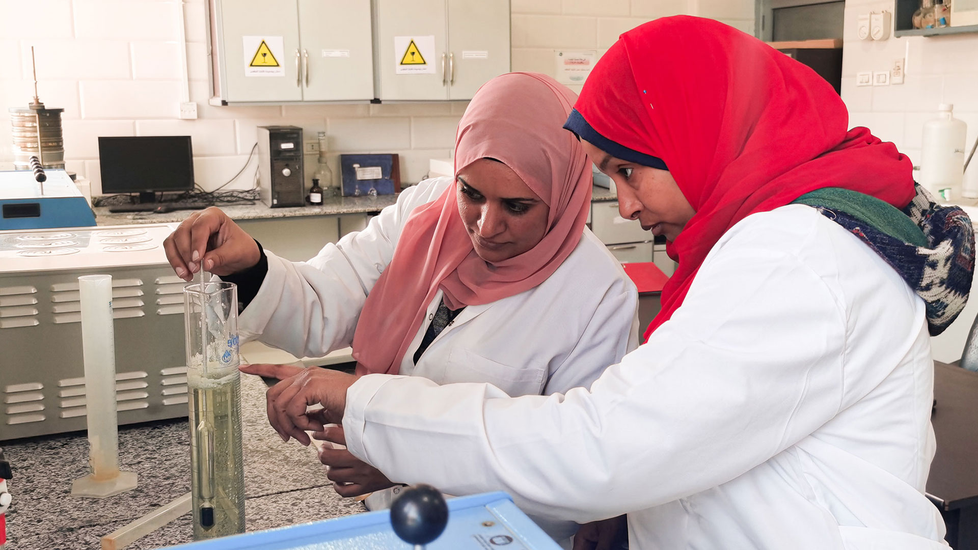 Chemists in a laboratory in Upper Egypt examine water samples to ensure the quality of produced water