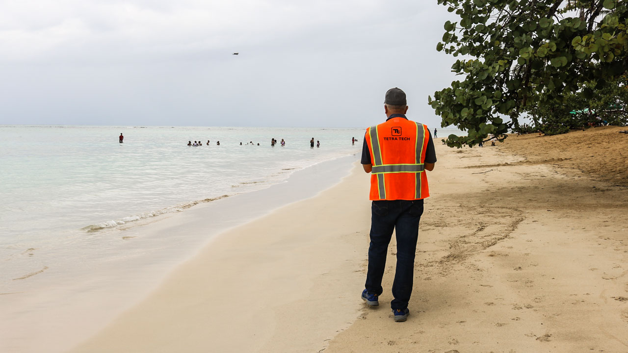 Tetra Tech employee conducts a marine litter drone survey to map ocean plastic pollution at a beach