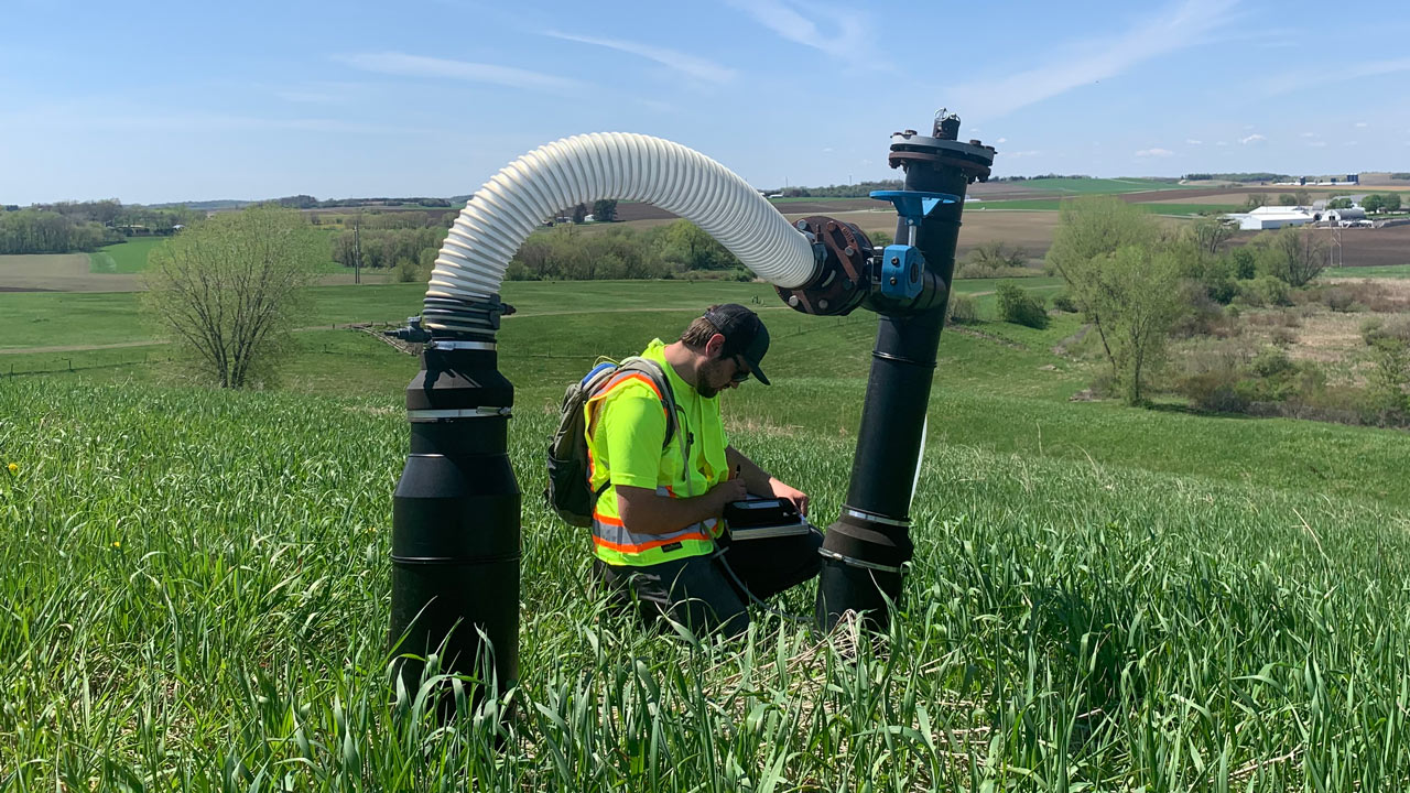 Tetra Tech technician collecting landfill gas sample for laboratory analysis