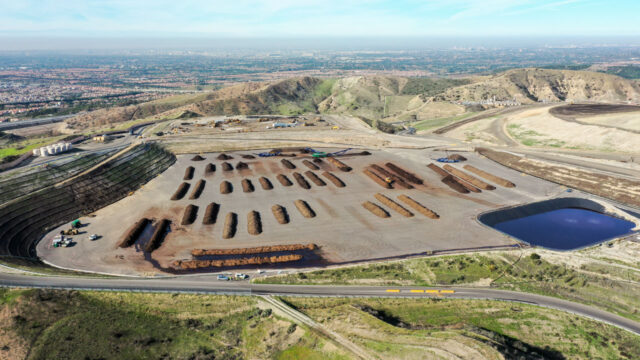 Aerial view of a organic waste composting facility producing soil amendment materials for agriculture with a blue sky in the background