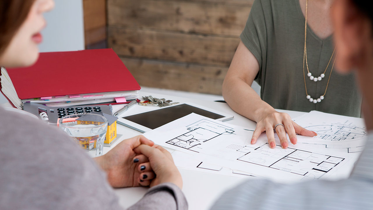 Close up of people sitting at a table reviewing site plans