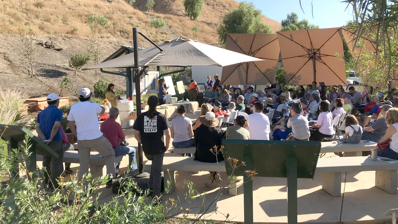 Group of people meeting outdoors to hear about ways to reduce food waste