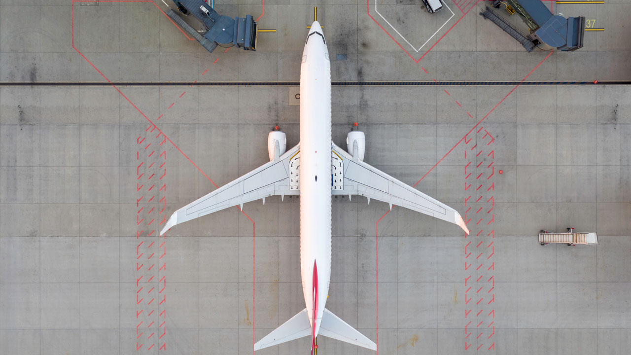 An overhead view of an airplane on a tarmac