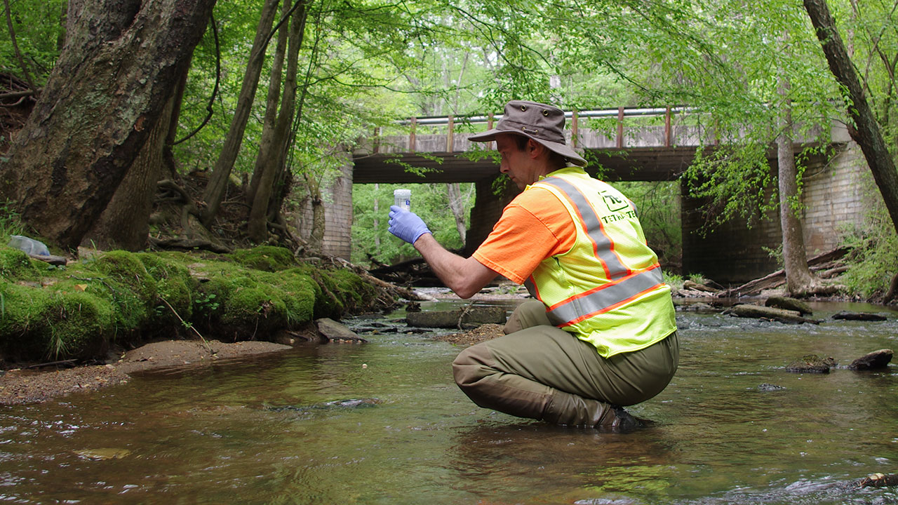Tetra Tech collects water quality sample in an urban stream outside of Atlanta, Georgia