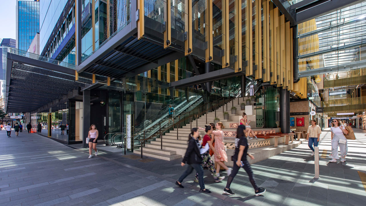 Pedestrians walking outside a busy Commercial Bay