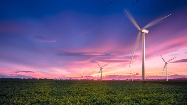 Three wind turbines on a green landscape