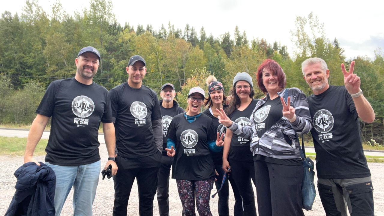 Tetra Tech employees in Healthy Life Challenge shirts smile for a photo while on a hike in Quebec