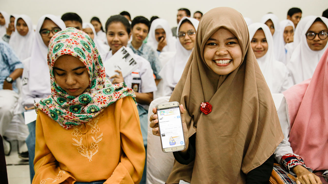 A student visits the official film festival Twitter page on her mobile phone