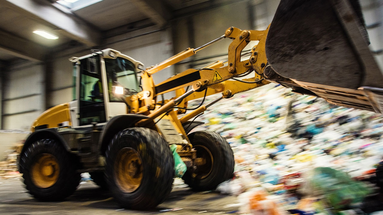 Bulldozer moving waste inside a transfer station