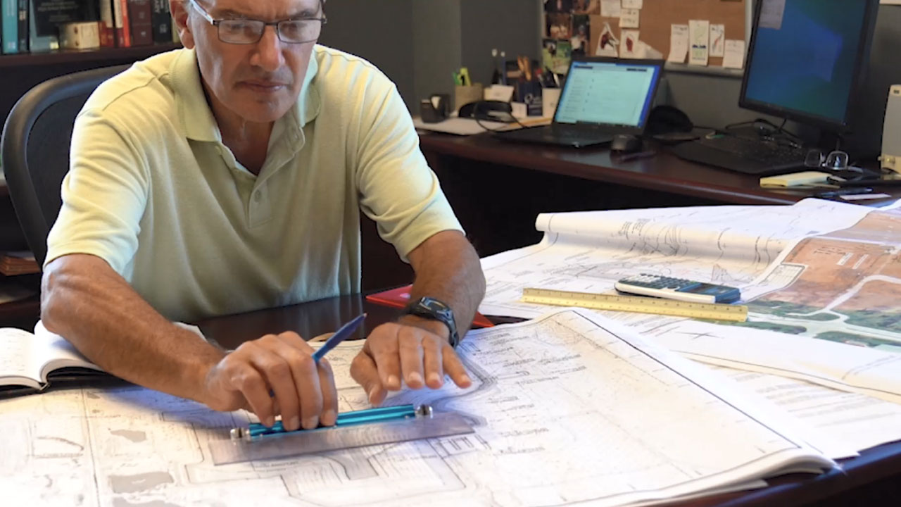 Man reviewing civil, structural, mechanical, and electrical details for a transfer station