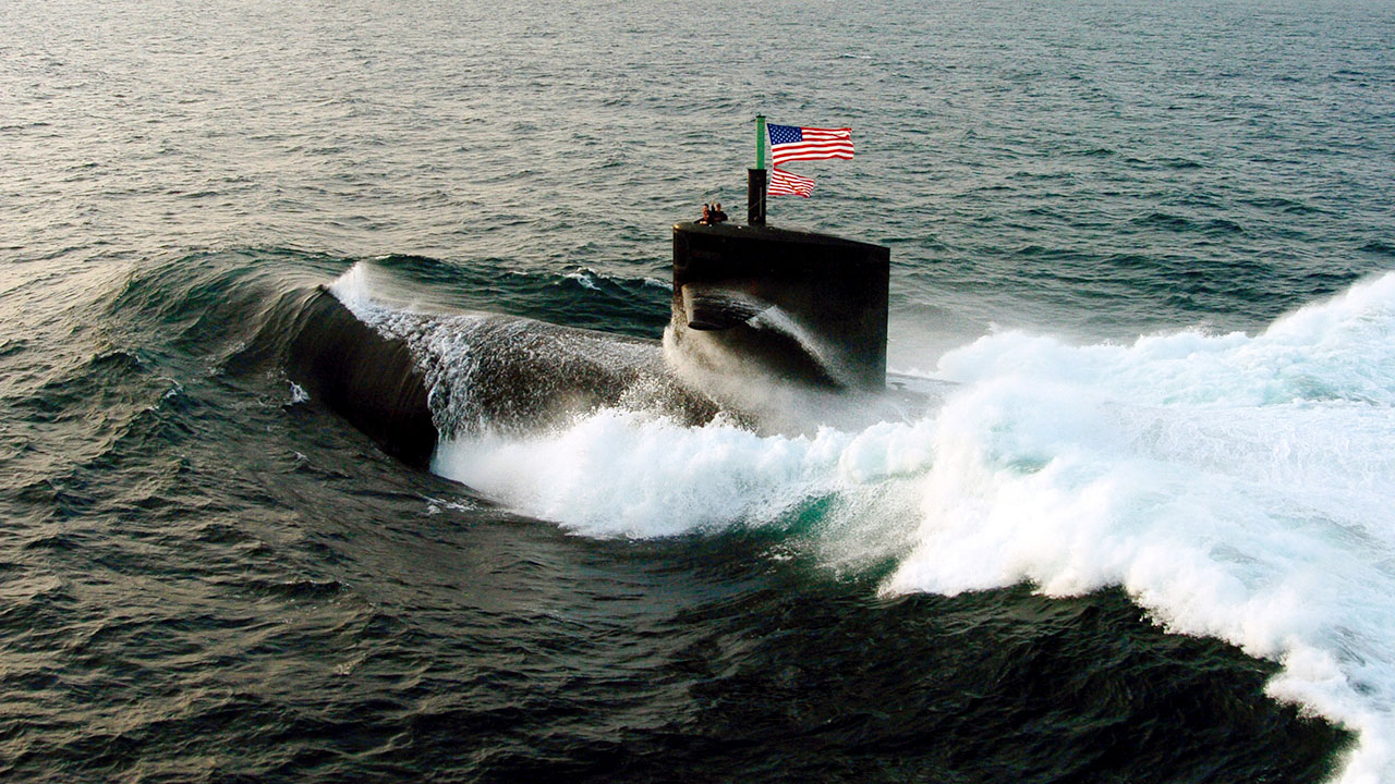 Submarine with a United States flag on top conducting a bilateral exercise on the ocean