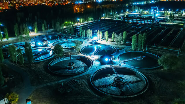 Aerial view at night of wastewater treatment plant, filtration of dirty or sewage water