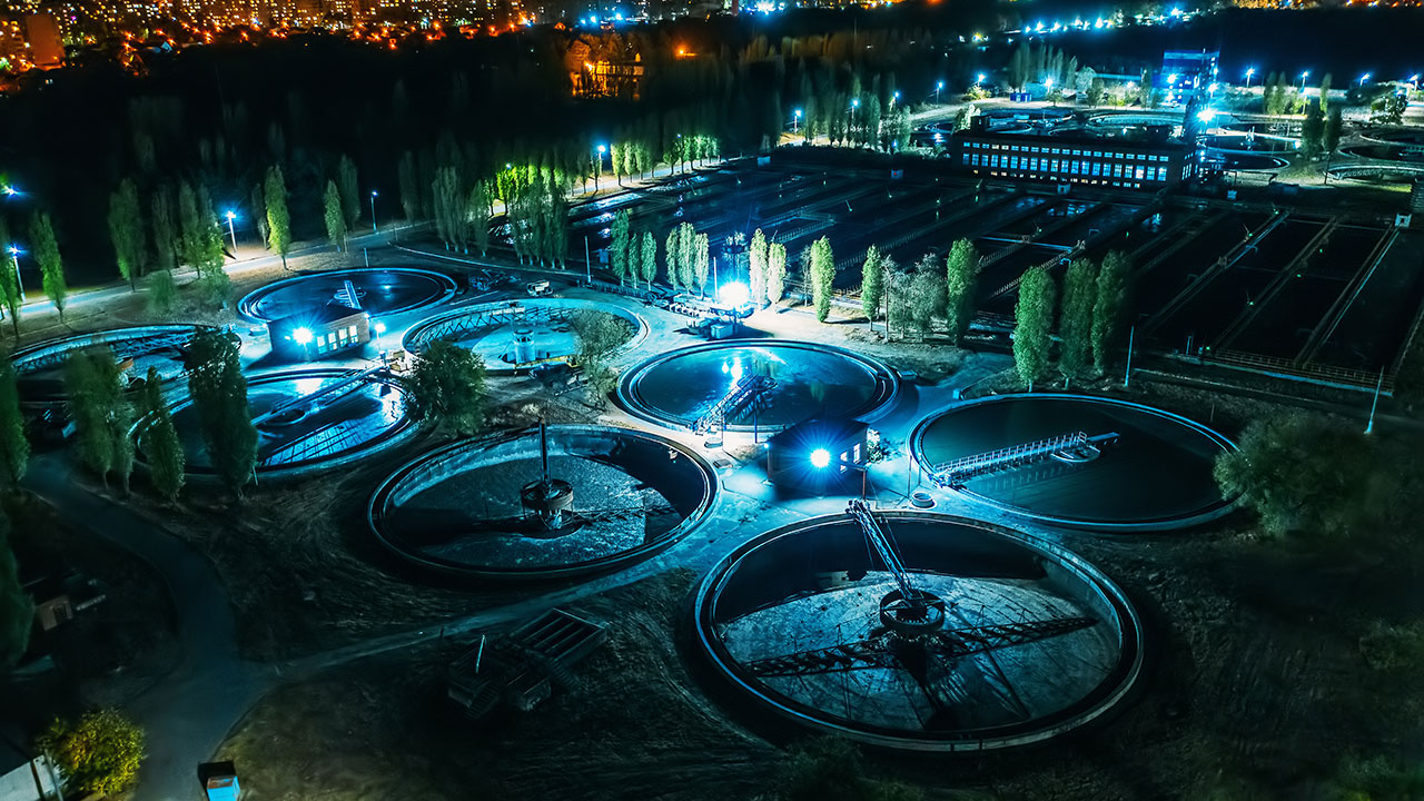 Aerial view at night of wastewater treatment plant, filtration of dirty or sewage water