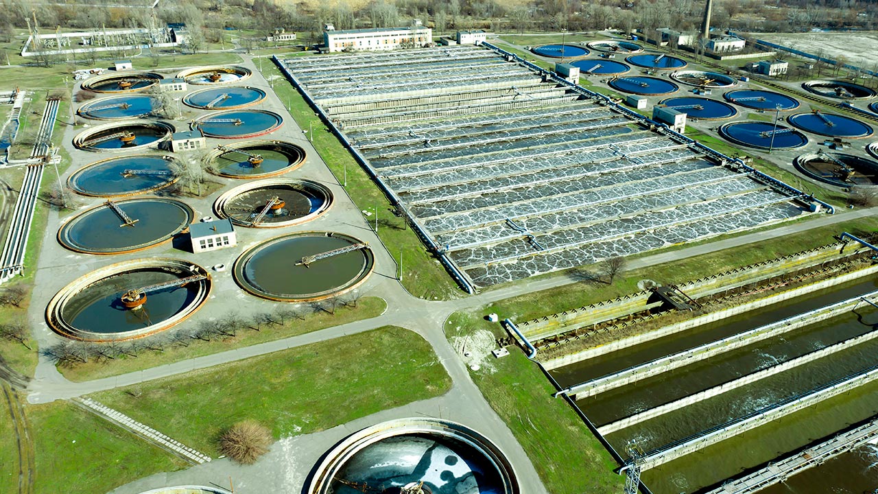 Aerial view at night of wastewater treatment plant, filtration of dirty or sewage water