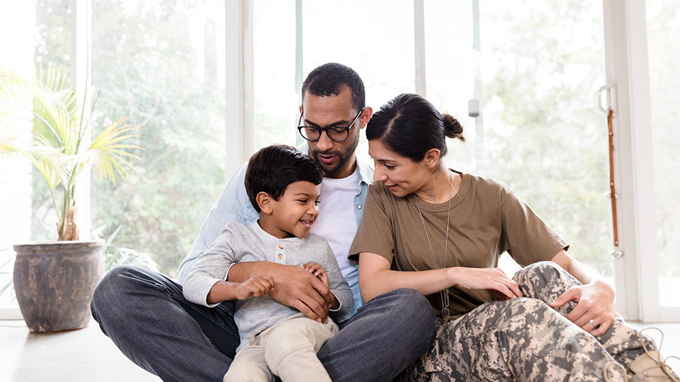 Couple sitting with a child in their home