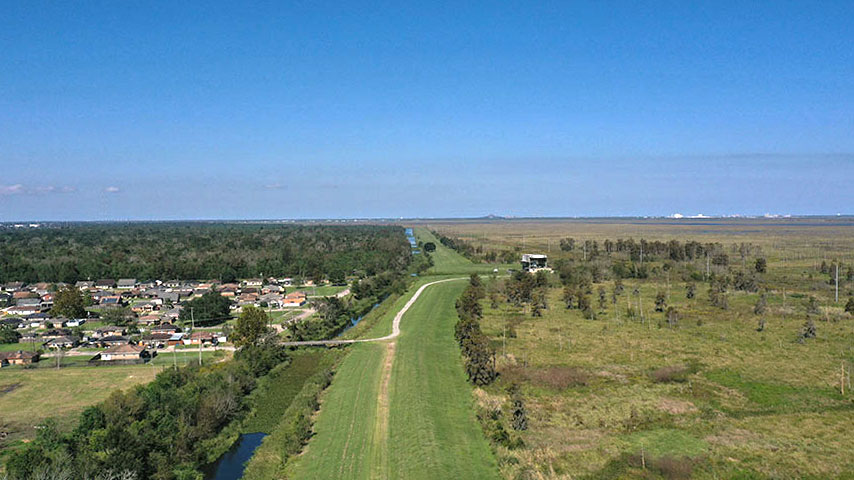 View along the earthen levee—Central Wetlands is the flooding source (right) and protection is provided to adjacent residents