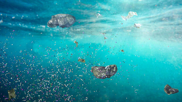 Underwater view of plastic pollution in ocean water and microplastics in the current
