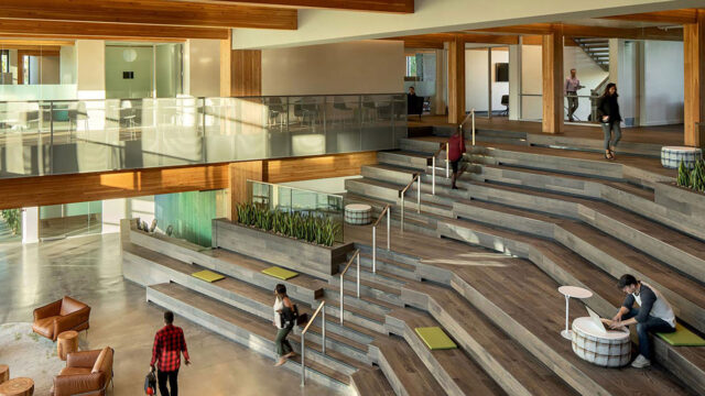 Rendering of the lobby area of a credit union building with daylighting, integrated seating areas, and biophilic elements
