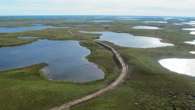 Aerial view of Inuvik Tuktoyaktuk Highway, a 140-kilometer, two-lane gravel road over complex ice-rich permafrost terrain