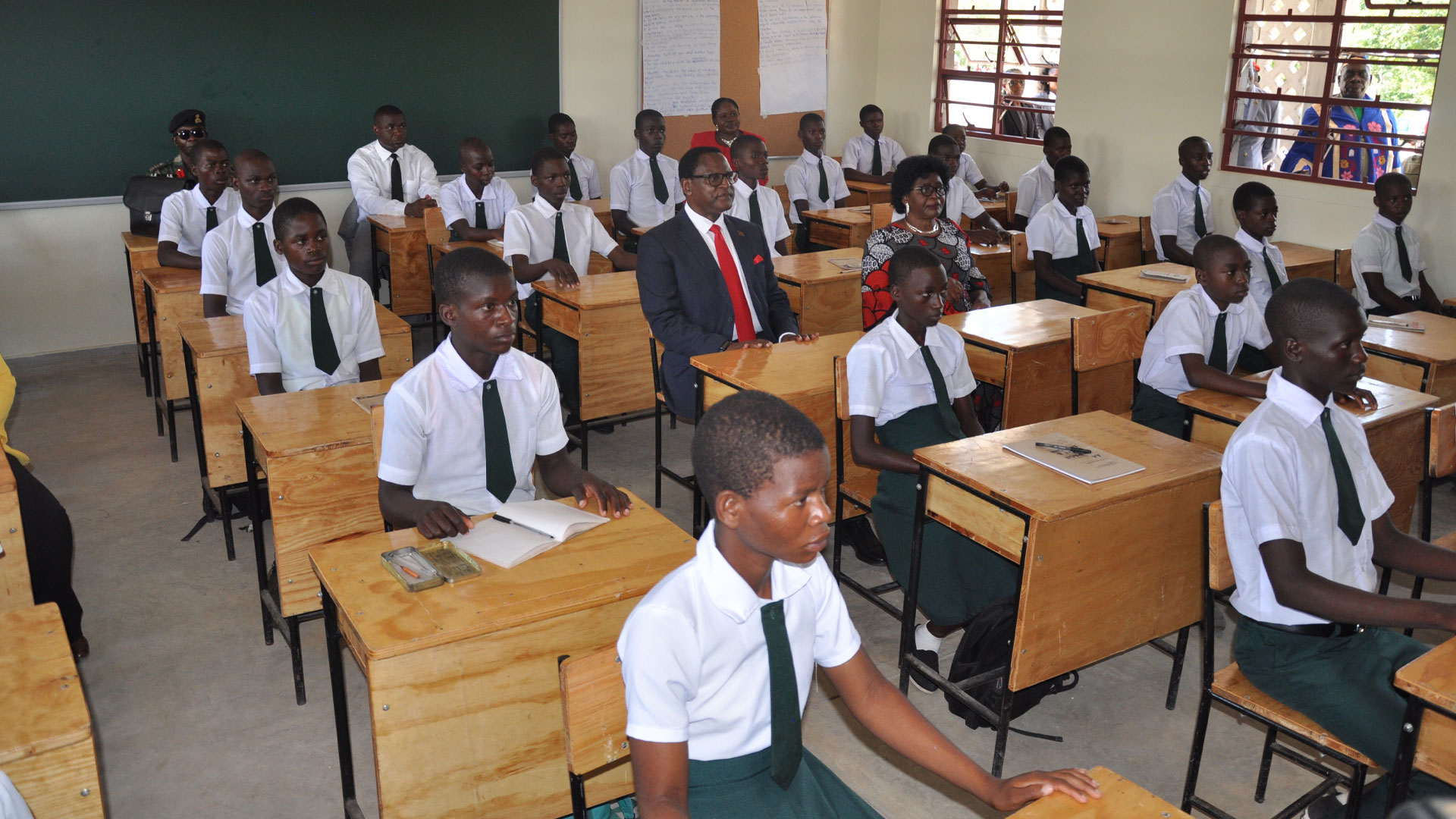 Malawi President and First Lady sit in a SEED Classroom in Mkanga, Salima among other students at their desks