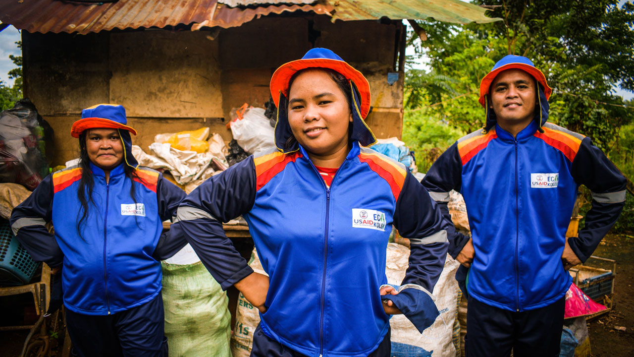 Three informal waste workers who have received personal protective equipment and technical training to improve their economic opportunities