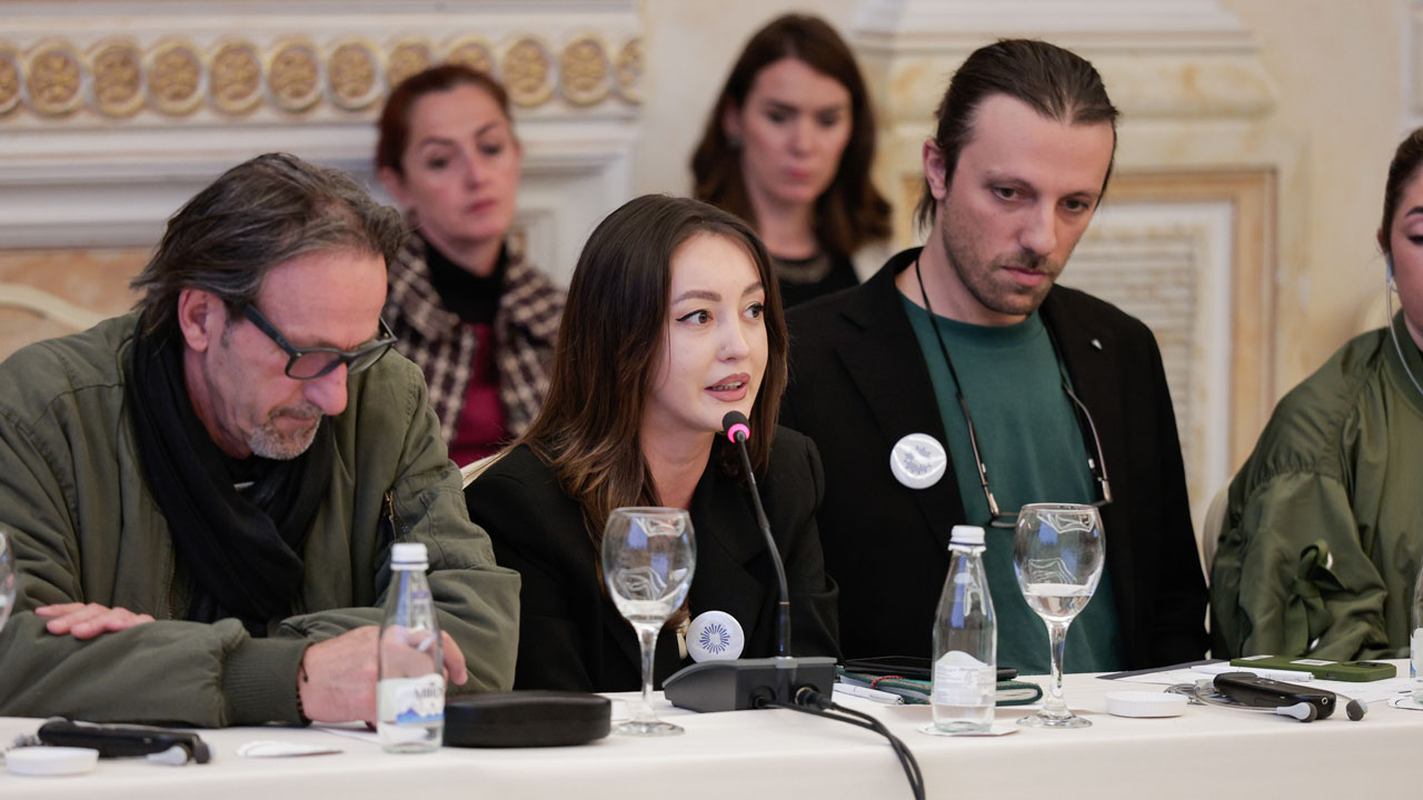 A woman shares her perspective at a project stakeholder meeting
