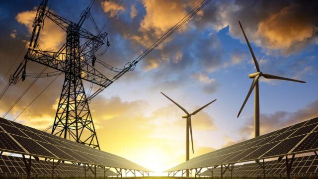 Solar panels, pylon, and wind turbines in a field