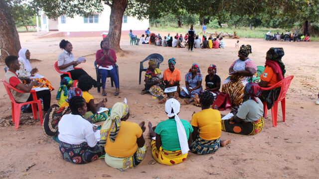 A group of women sit in a circle for a training in Nampula, Mozambique