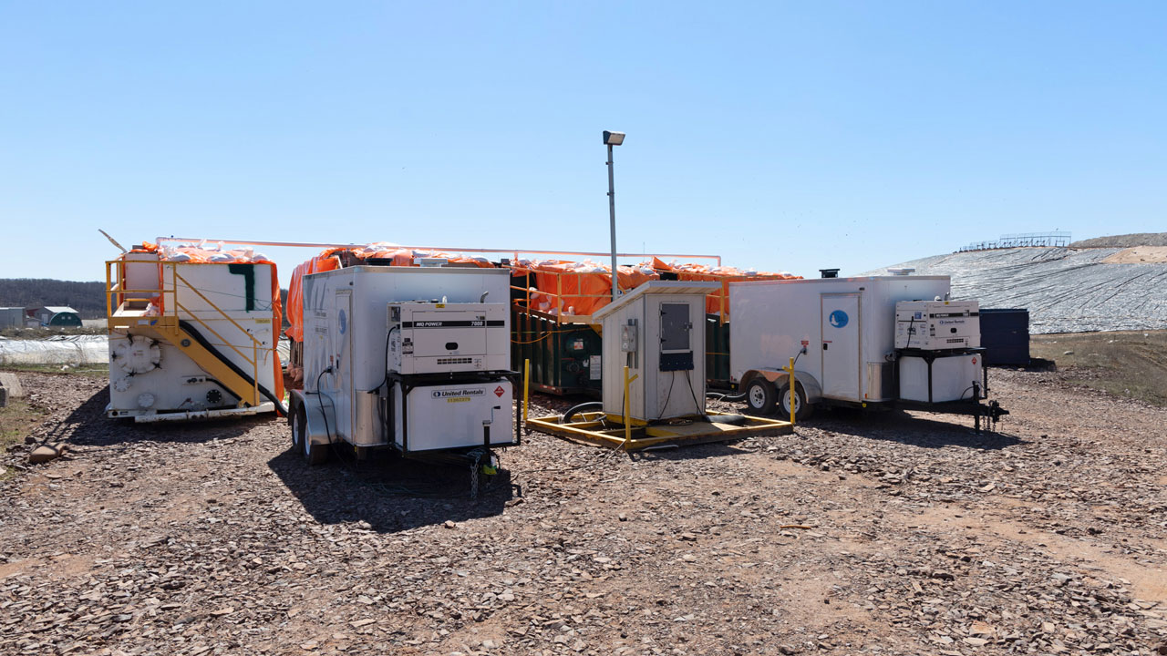 Several small outbuildings containing components of the current leachate management system