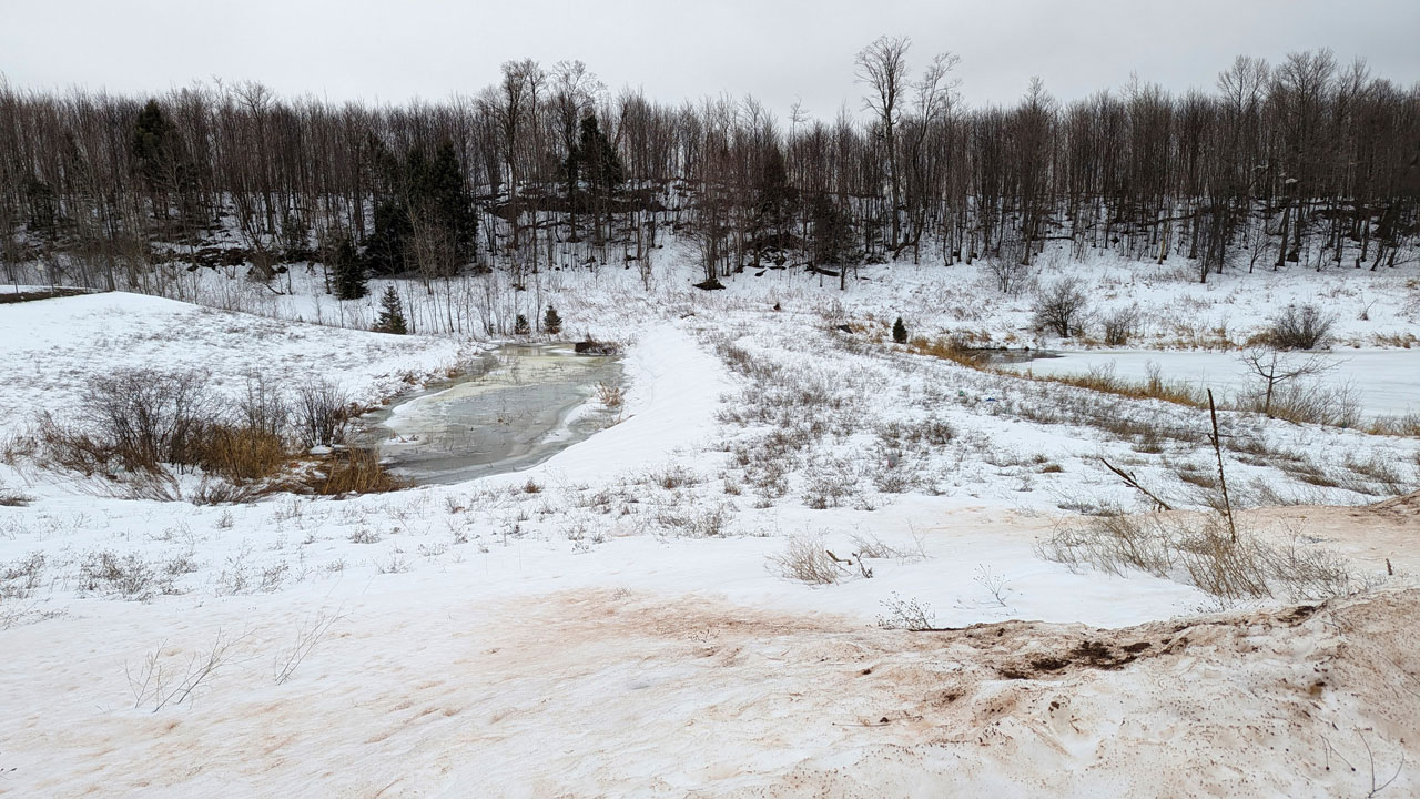 Empty snowy field with inlet that will be location of future reverse osmosis leachate treatment plant