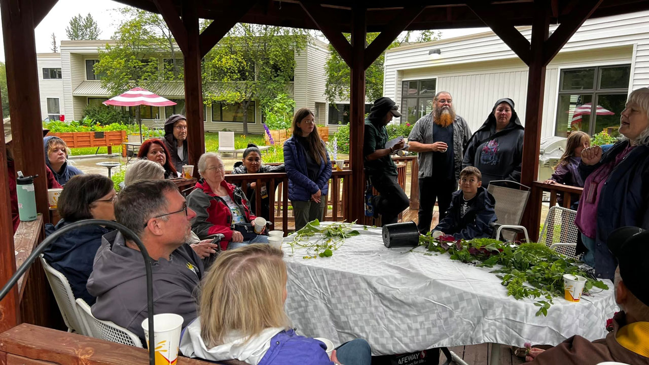 Community members gather in a gazebo to learn about sustainable food-related habits